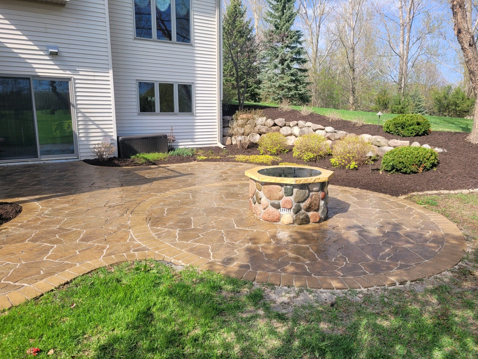 Backyard fire pit area with pavers
