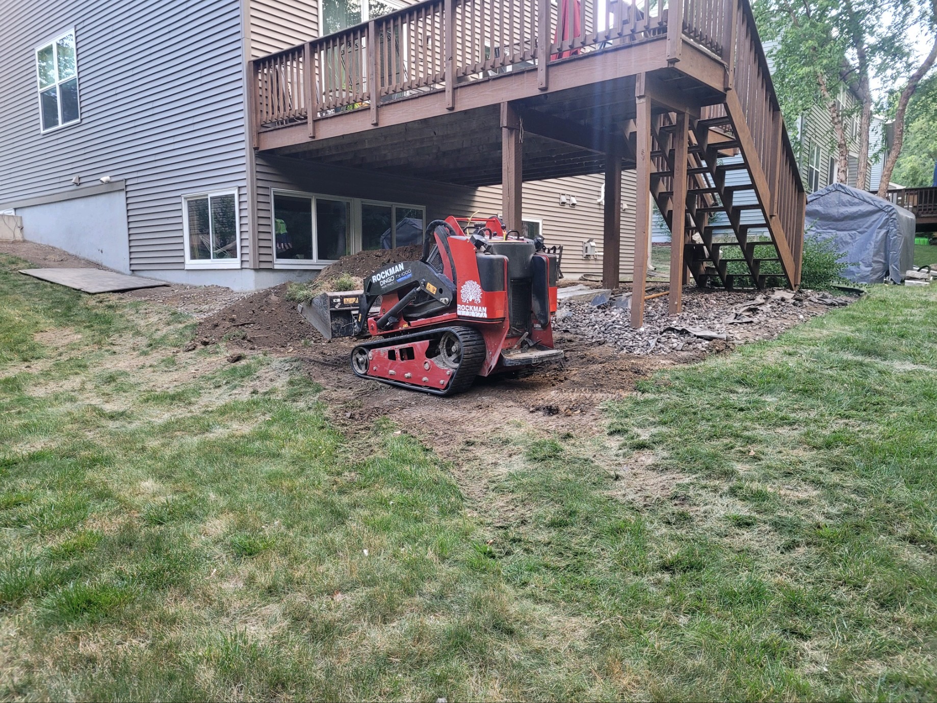 Skid steer regrading a backyard