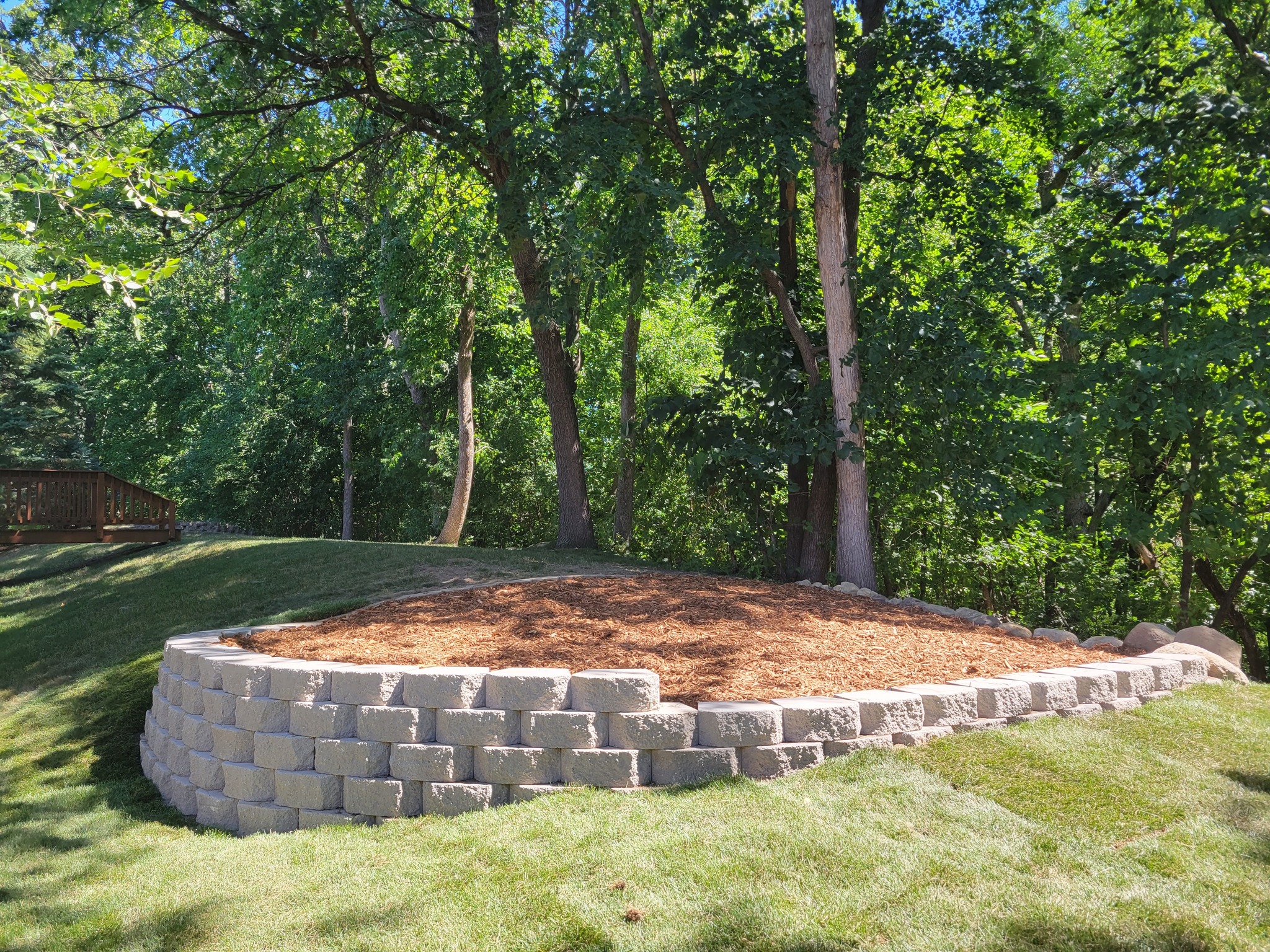 Stone retaining wall with planting bed